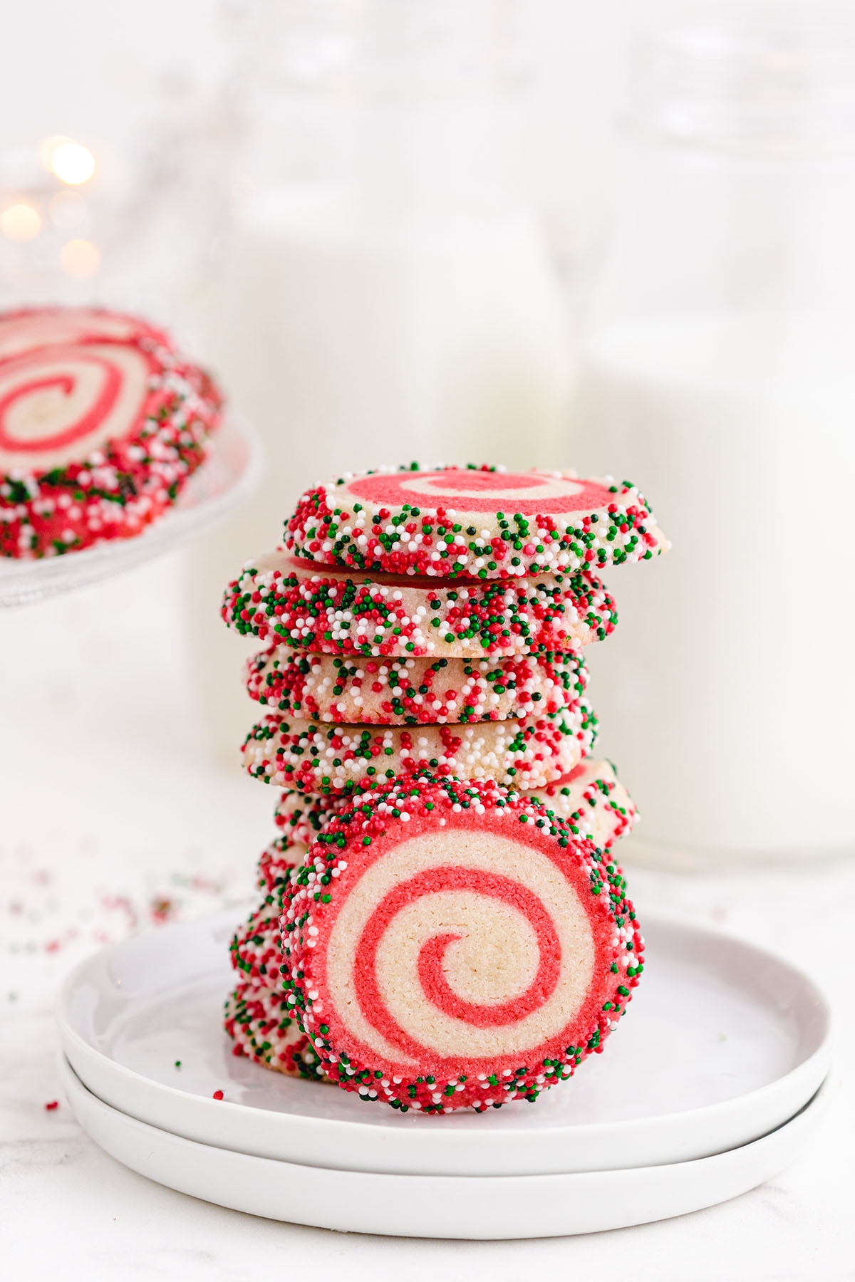 a stack of Christmas Pinwheel Cookies on a white plate.