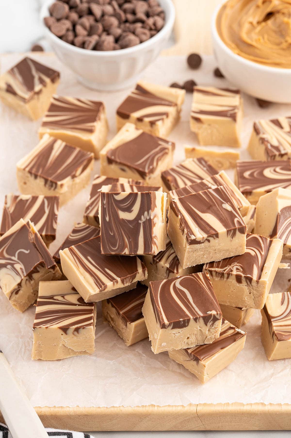 square cut of Tiger Butter Fudge on top of a wooden board.