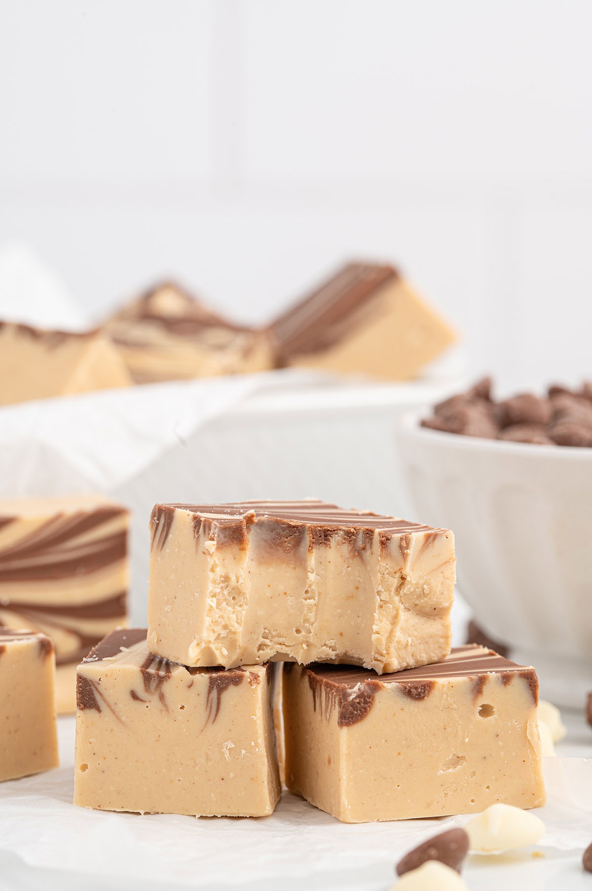 a stack of Tiger Butter Fudge over parchment paper.