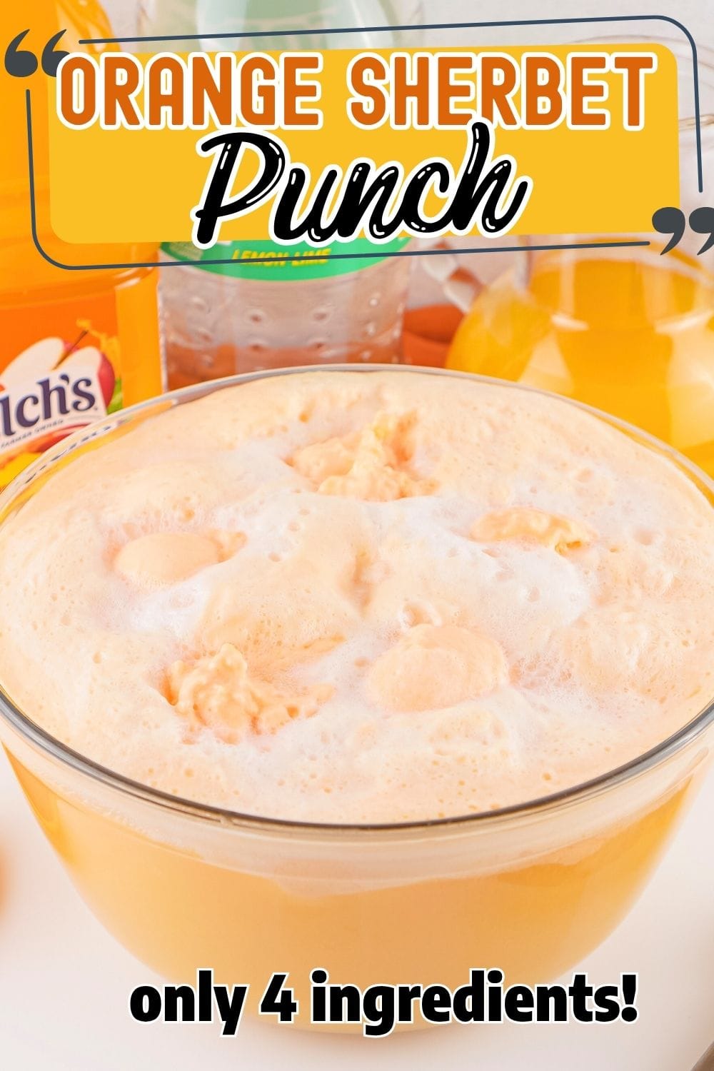 Orange sherbet punch with floating sherbet scoops in a glass punch bowl.