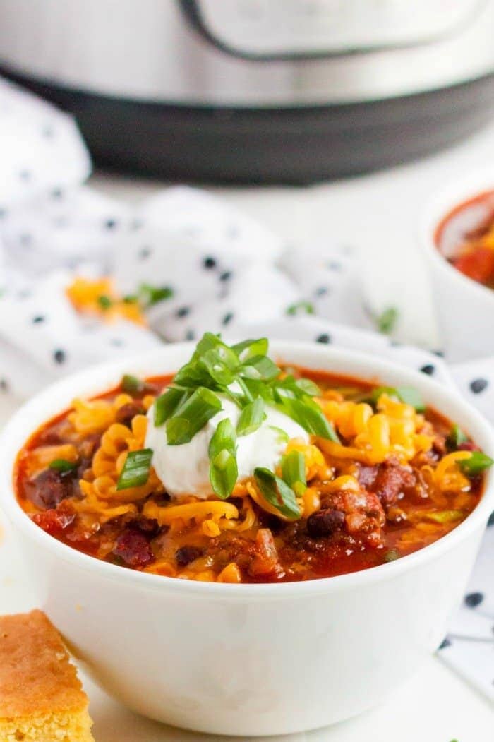 Instant Pot Chili in a white bowl with toppings
