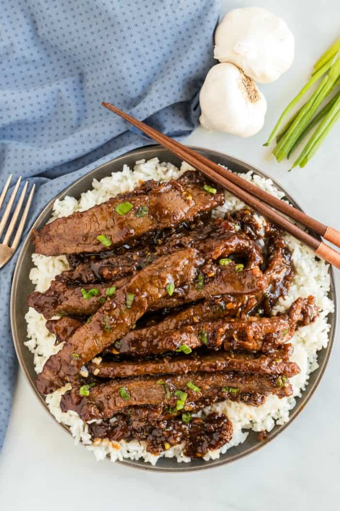 Mongolian Beef on a plate with chopsticks