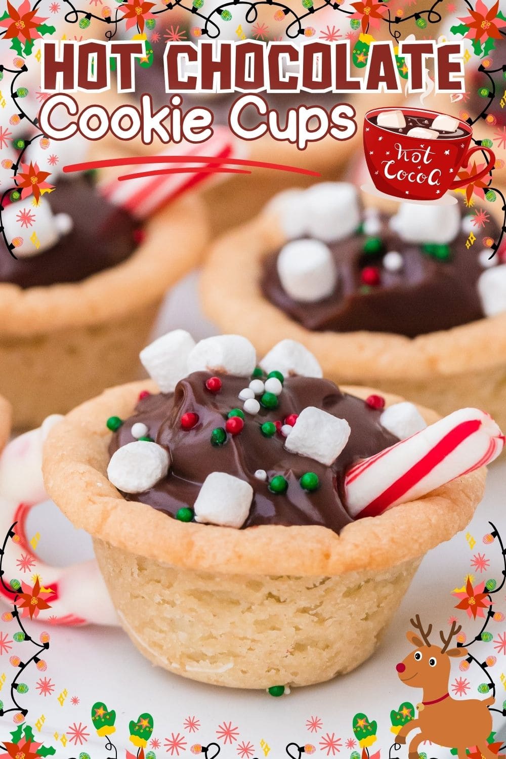 Festive hot chocolate cookie cups filled with chocolate and topped with mini marshmallows on a plate
