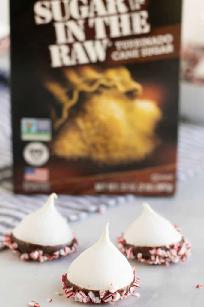 Chocolate Dipped Meringue Cookies in front of a Sugar in the Raw Box