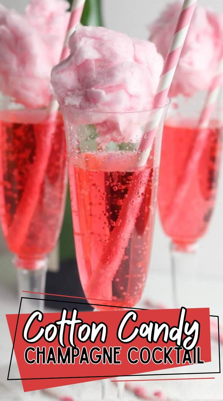 Pink cotton candy champagne cocktail with cotton candy on top of a glass of bubbly champagne.