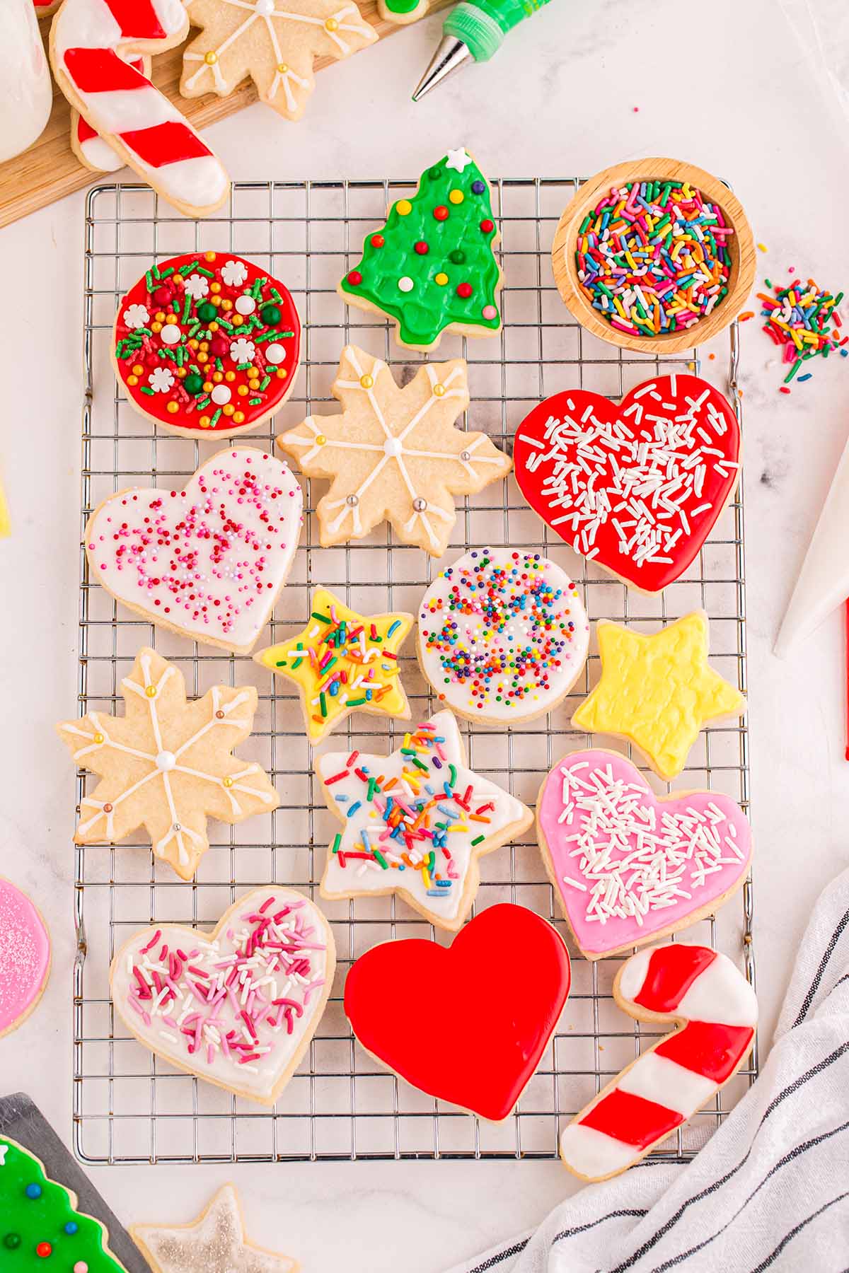 a couple of decorated cut out sugar cookies on a cooling rack.