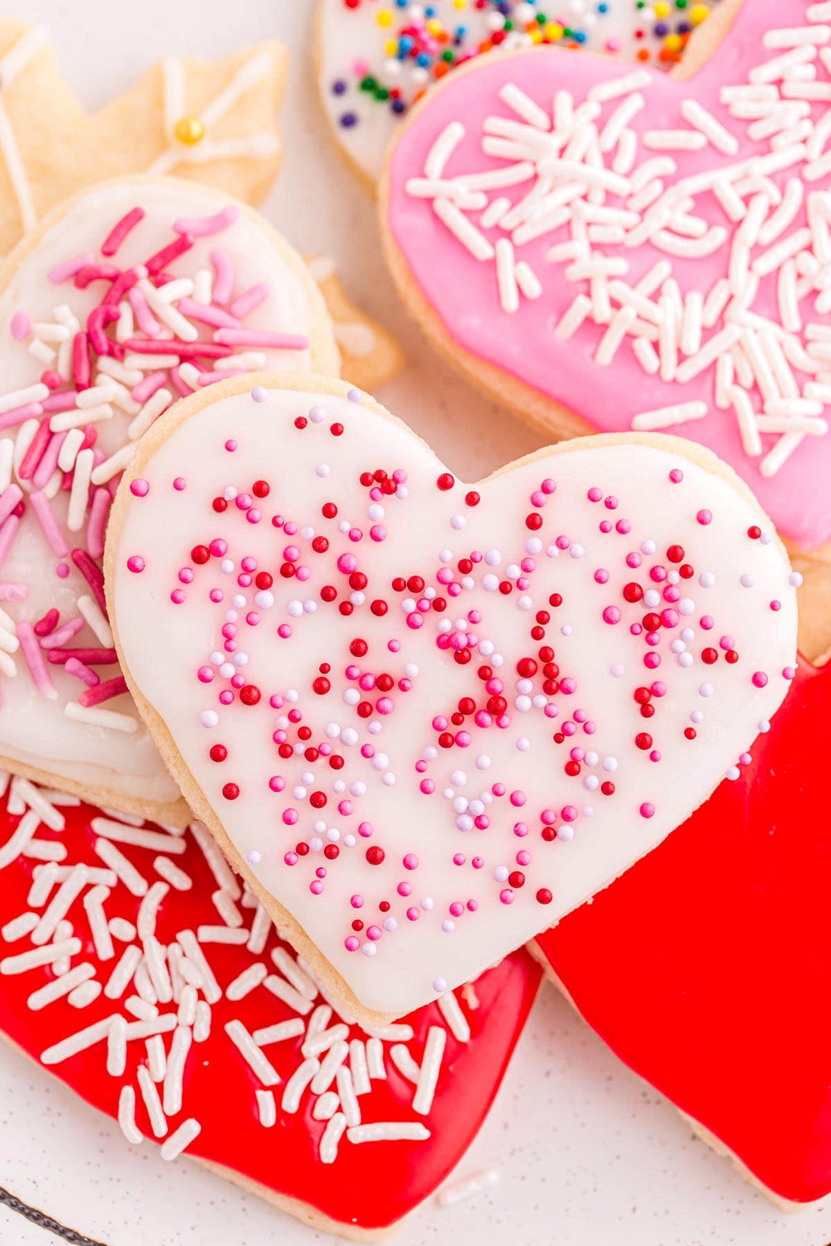 a couple of heart-shaped cut out sugar cookies with sprinkle.