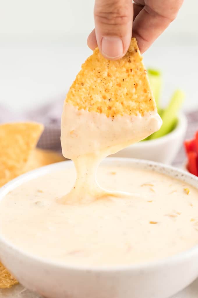 white queso dipping a chip