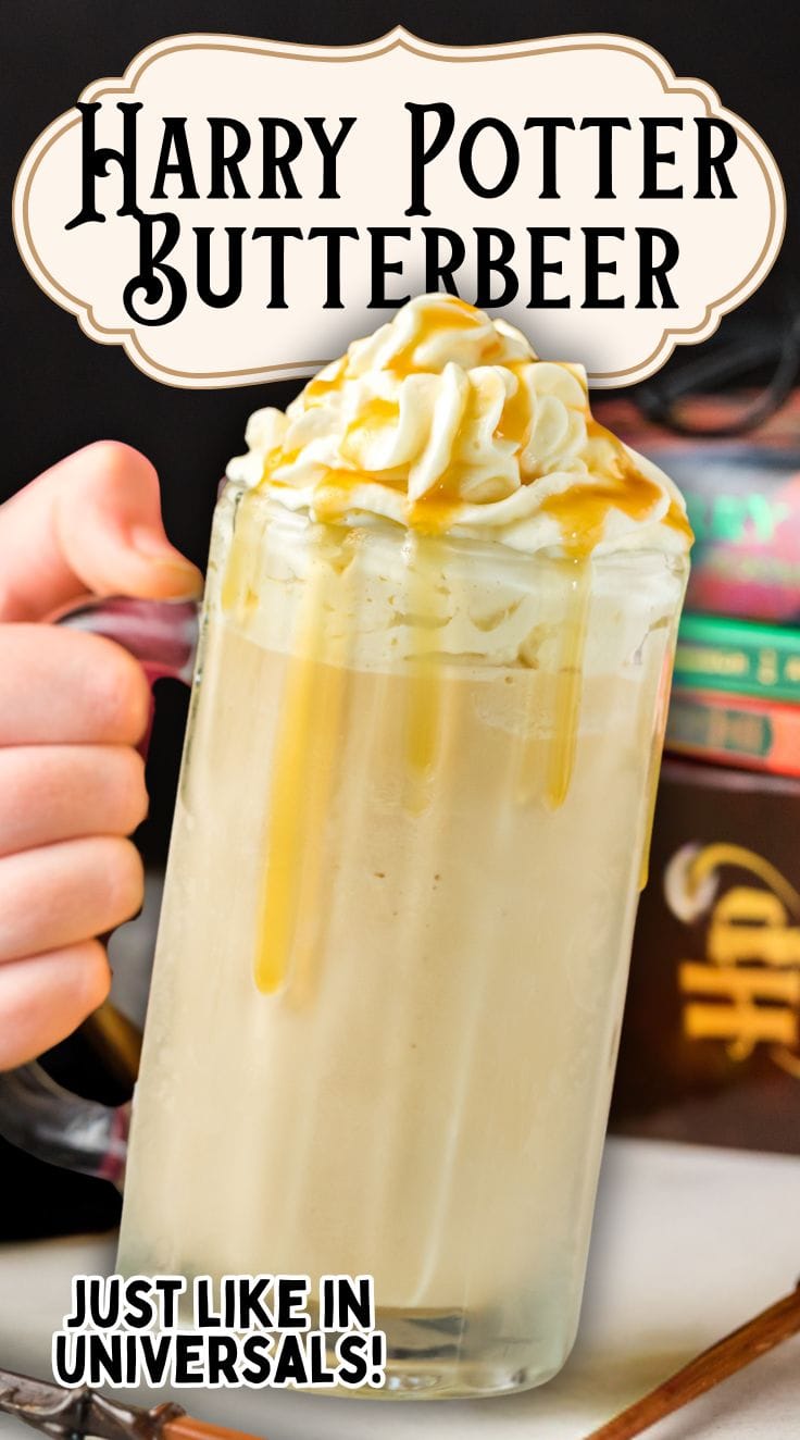 A hand holding a large cup of Butterbeer with Harry Potter novel in the background