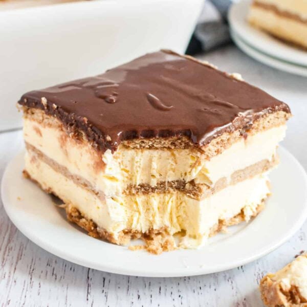 No-Bake eclair cake with a bite on a white plate
