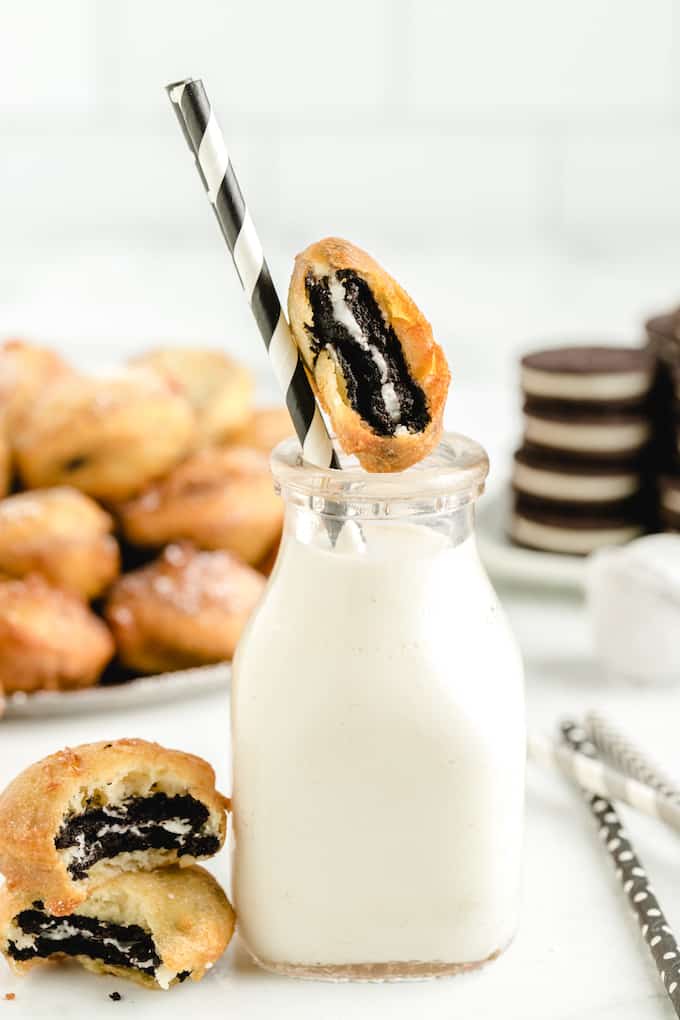 Deep Fried Oreos with milk and a black and white straw