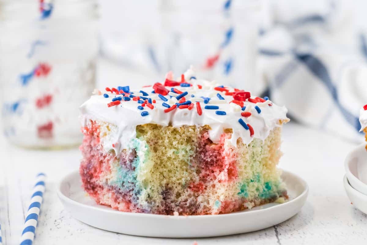 piece of red white and blue jello poke cake on a white plate