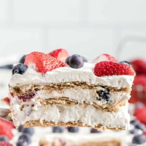 Berry Icebox Cake featured image sliced on a spatula