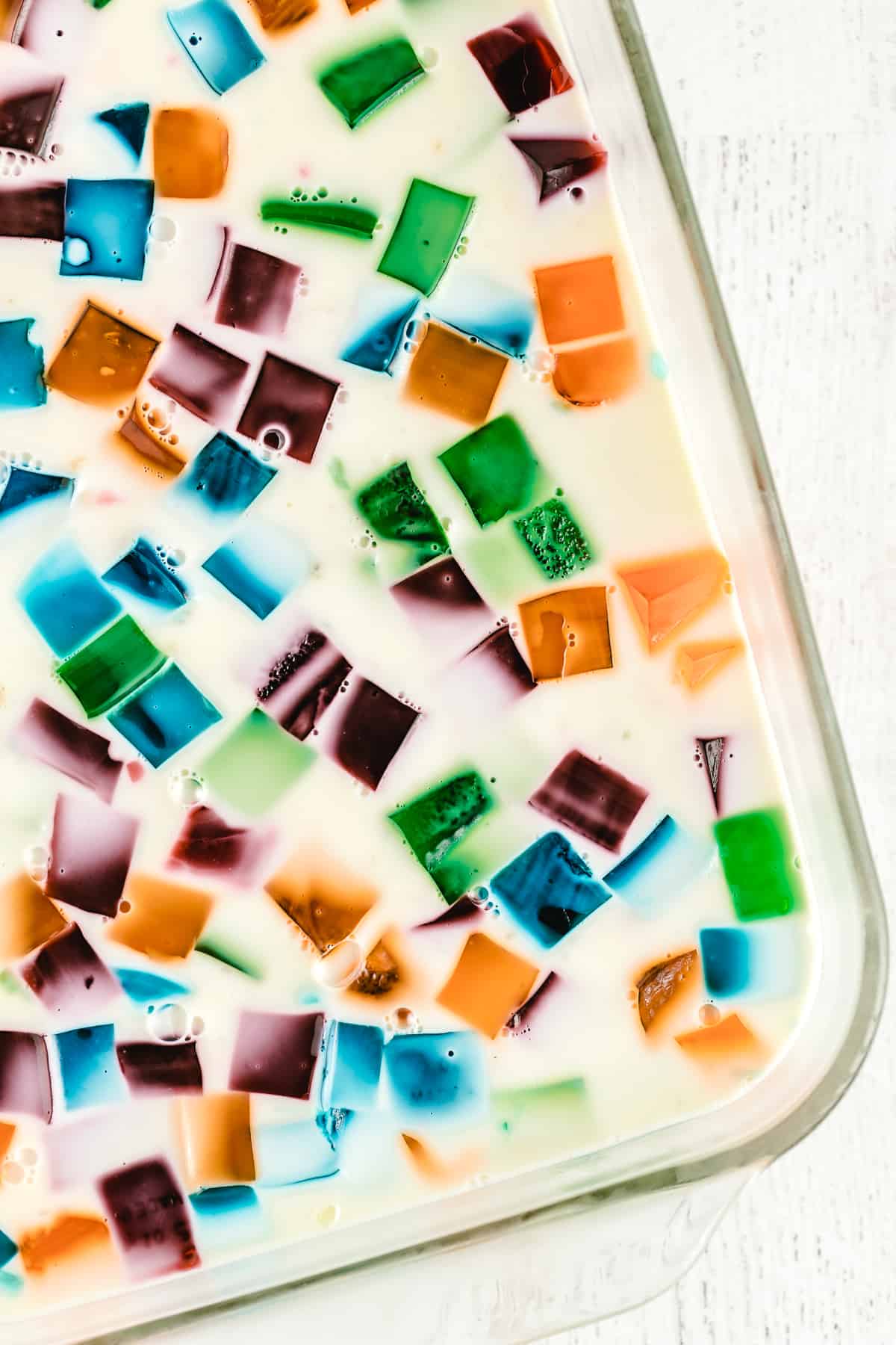 Jello with colored jello cubes in a glass dish