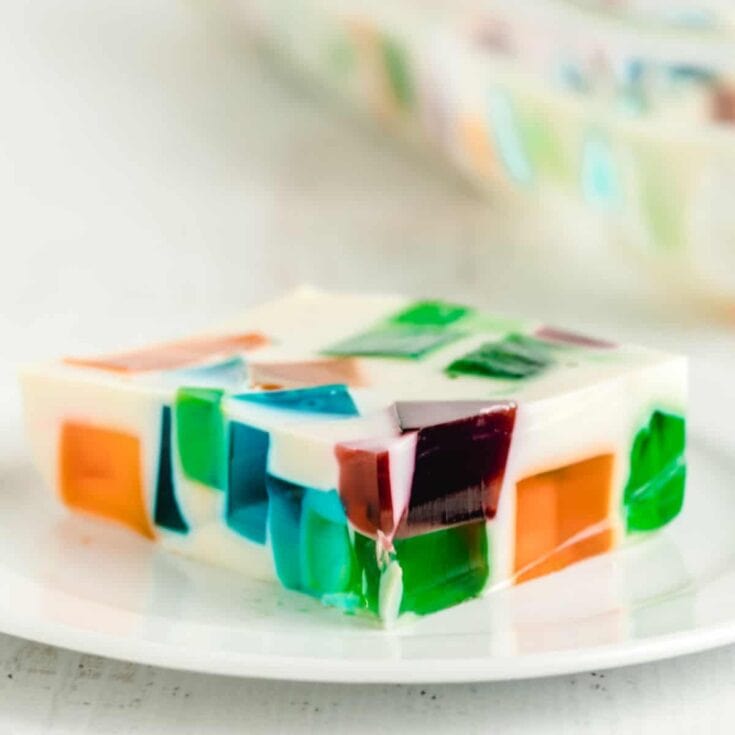 A piece of broken glass Jello on a white plate.