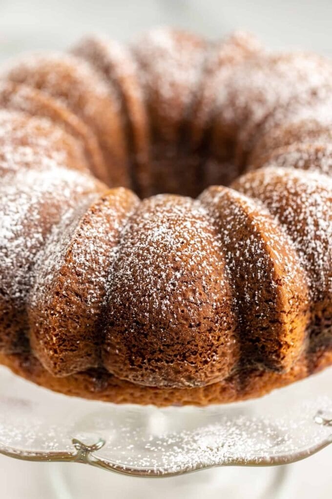 Close up of a chocolate Cake on a cake stand with powdered sugar