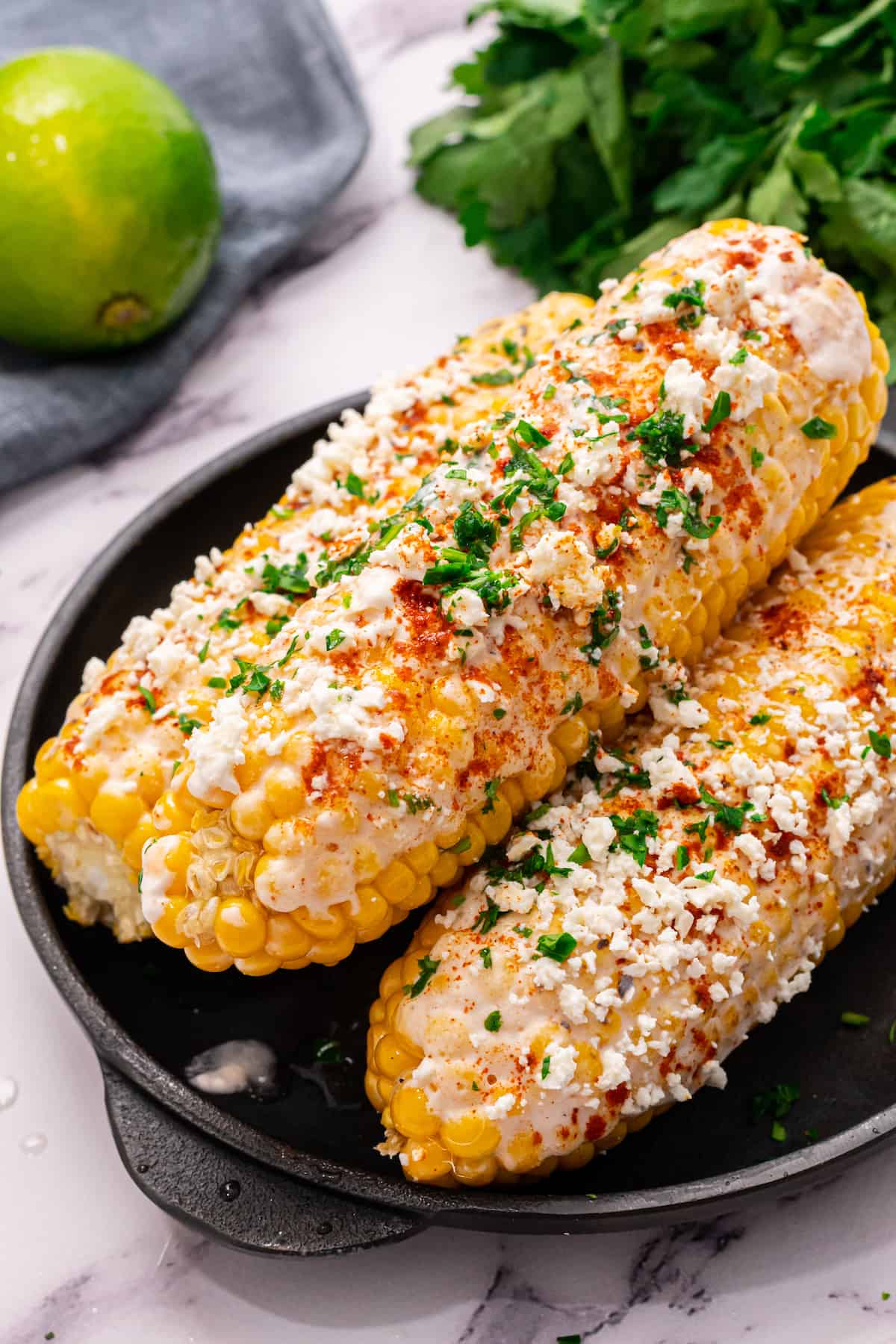Corn with Mexican seasoning on a black plate