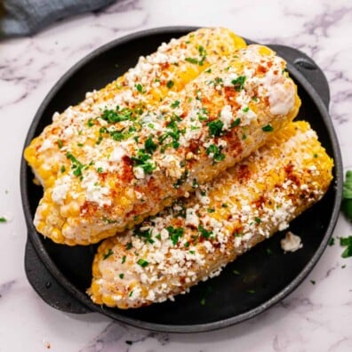 Mexican Street corn on a black plate