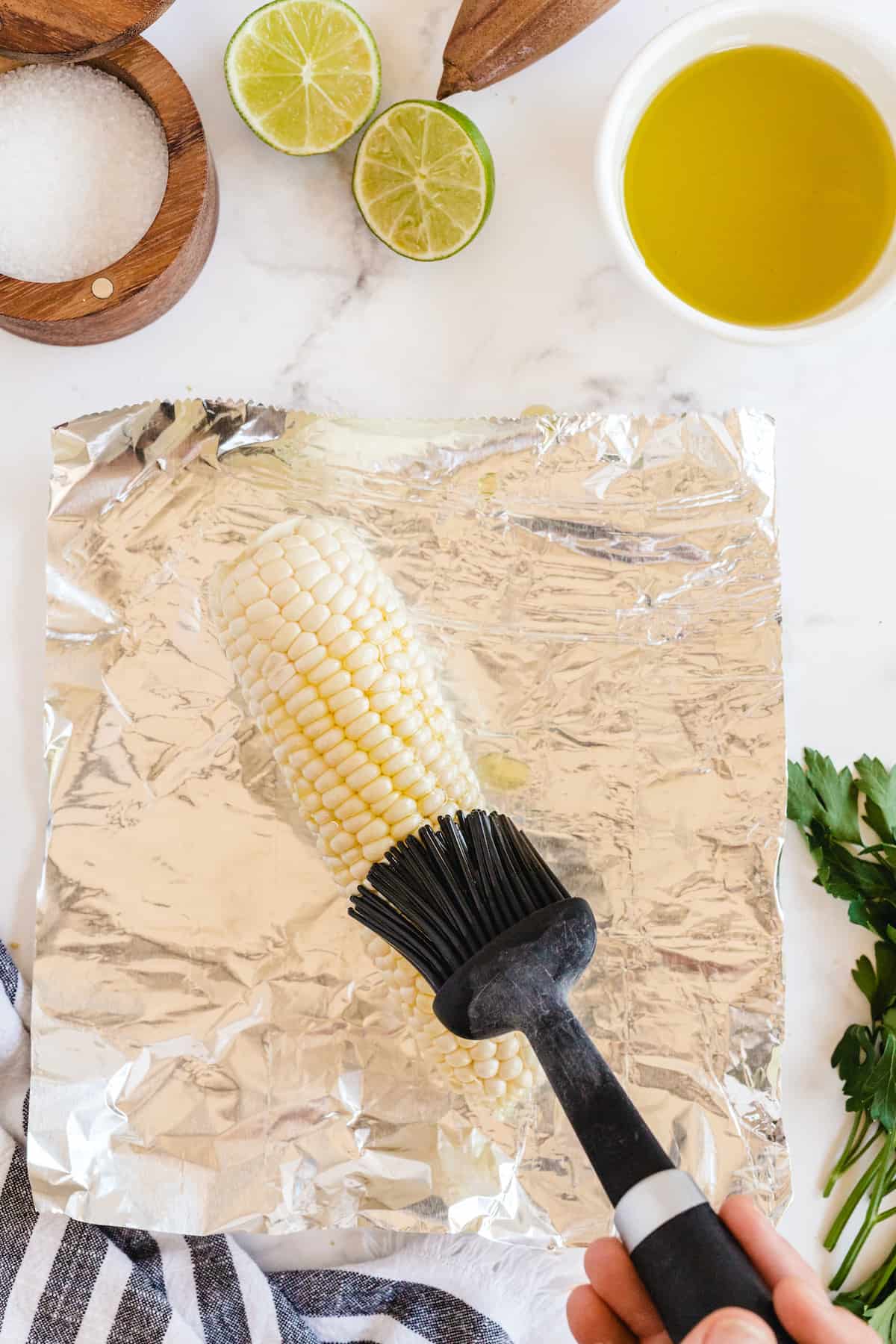 brush corn with olive oil