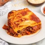 a square of upside down pizza on a plate.