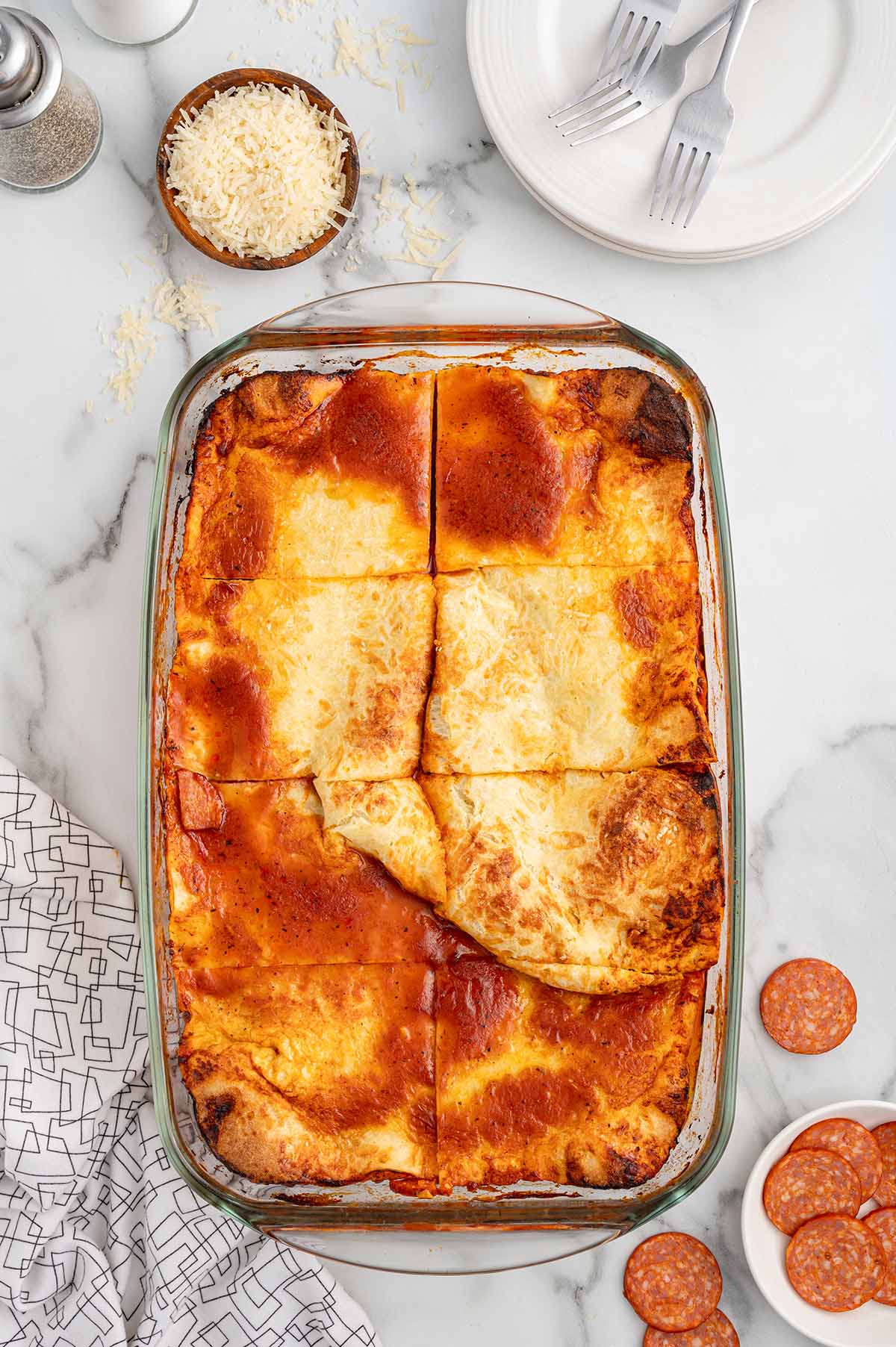 upside down pizza in a baking dish cut into squares.