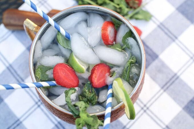 moscow mule with ice, strawberries, mint leaves and lime