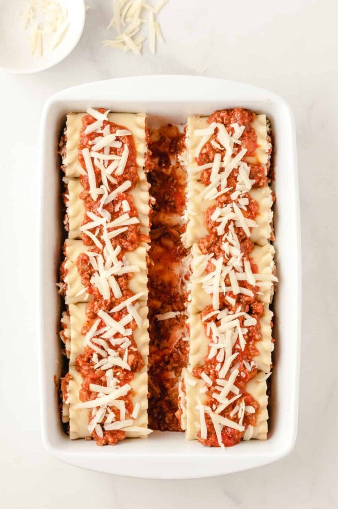 Lasagna Roll-Ups prior to baking with sauce and cheese on top