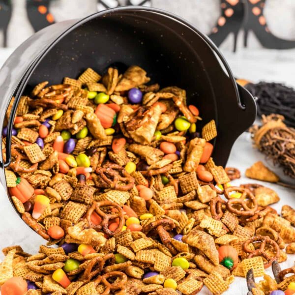 Halloween Chex Mix in a bowl spilling out