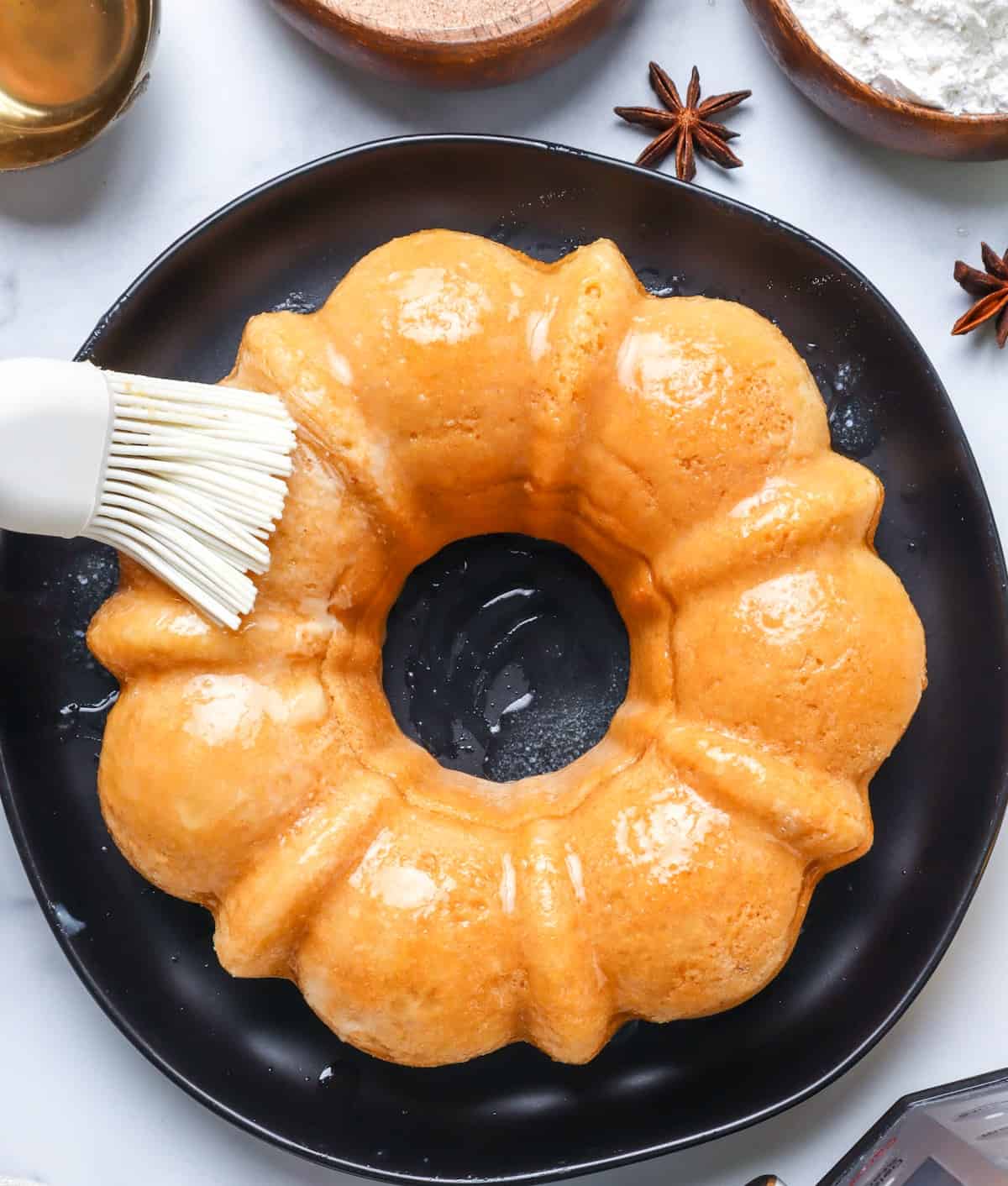 buttering cake on a black plate