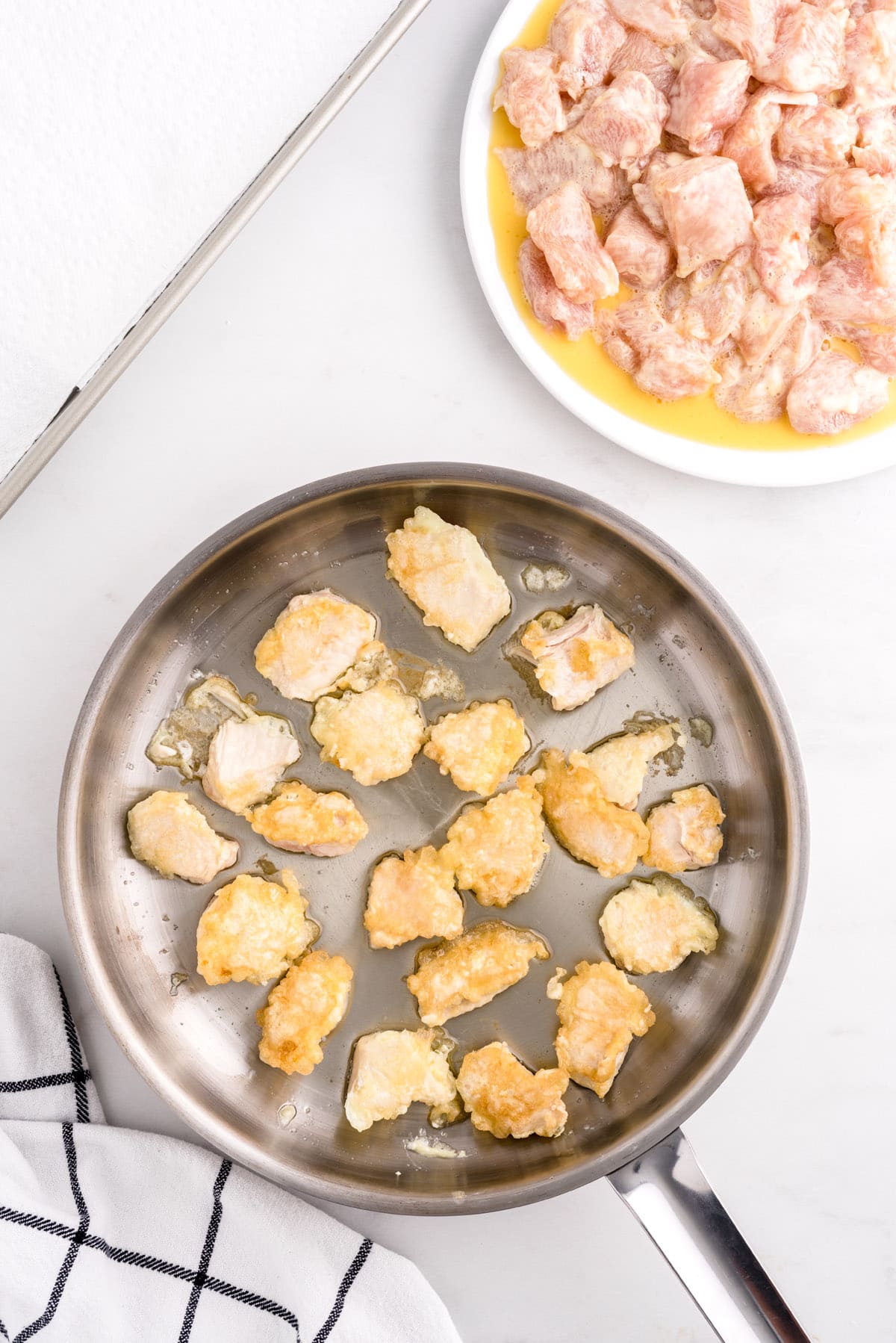 gently place ½ of your coated chicken pieces into the oil in a single layer