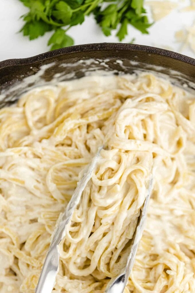 close up of pasta with Alfredo sauce in a pan