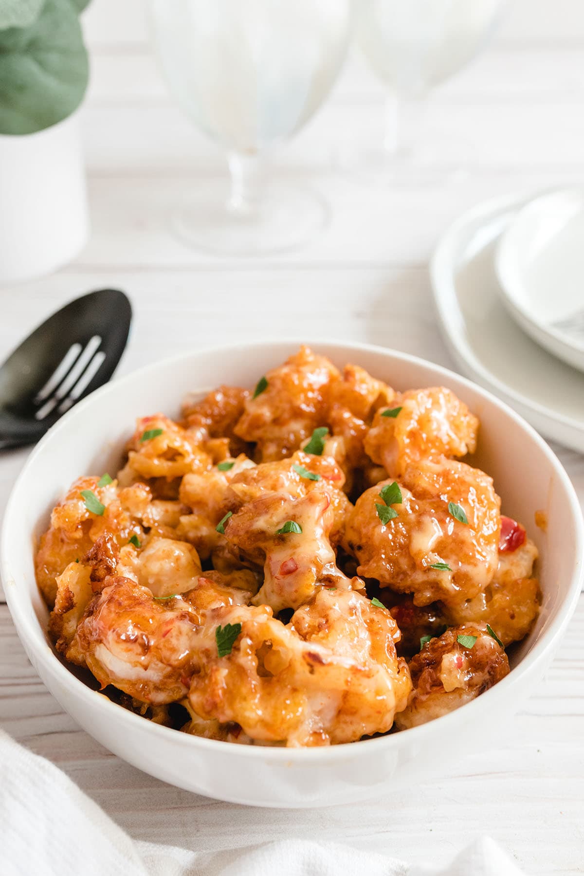 bang bang shrimp in a bowl placed on top of the table. 