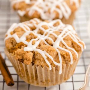 pumpkin muffin with icing on a wire rack