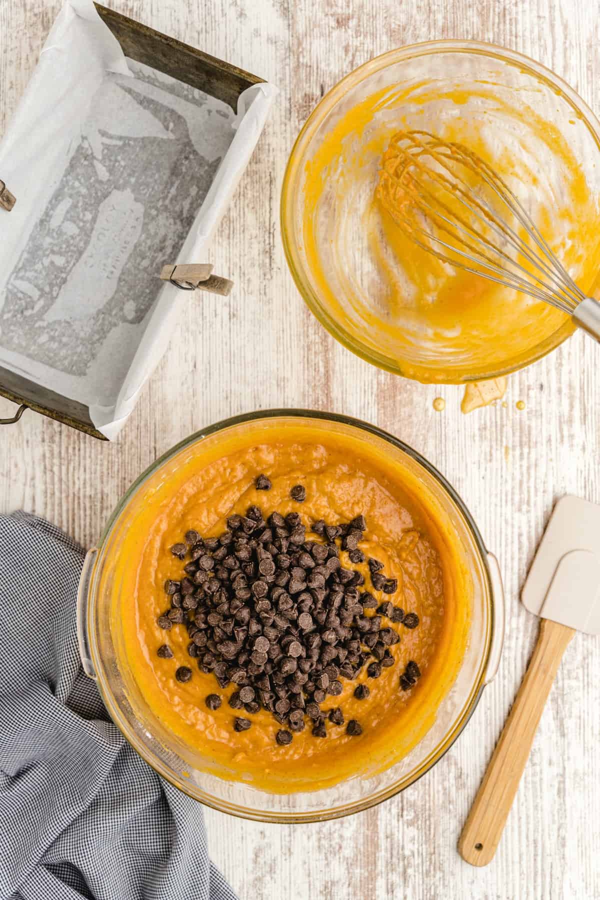 pumpkin bread batter in a glass bowl with chocolate chips