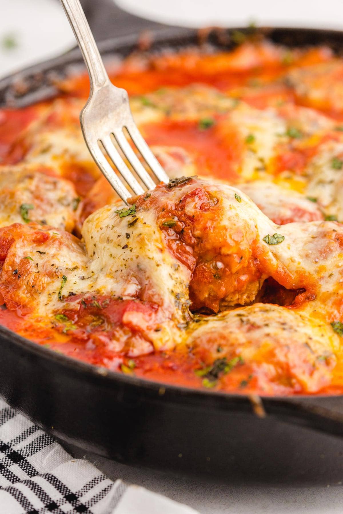 meatball parmetesan in a skillet.