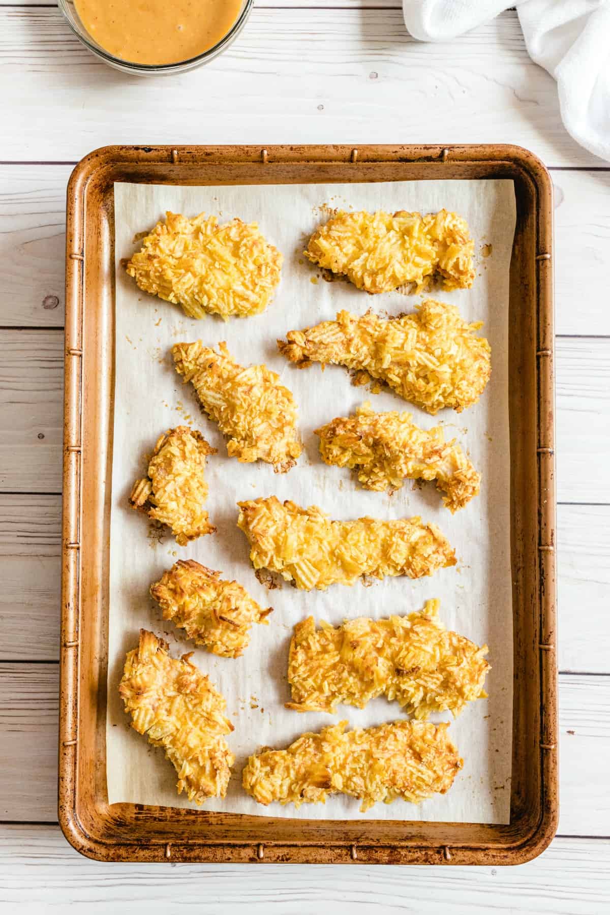 baked chicken strips on a baking sheet