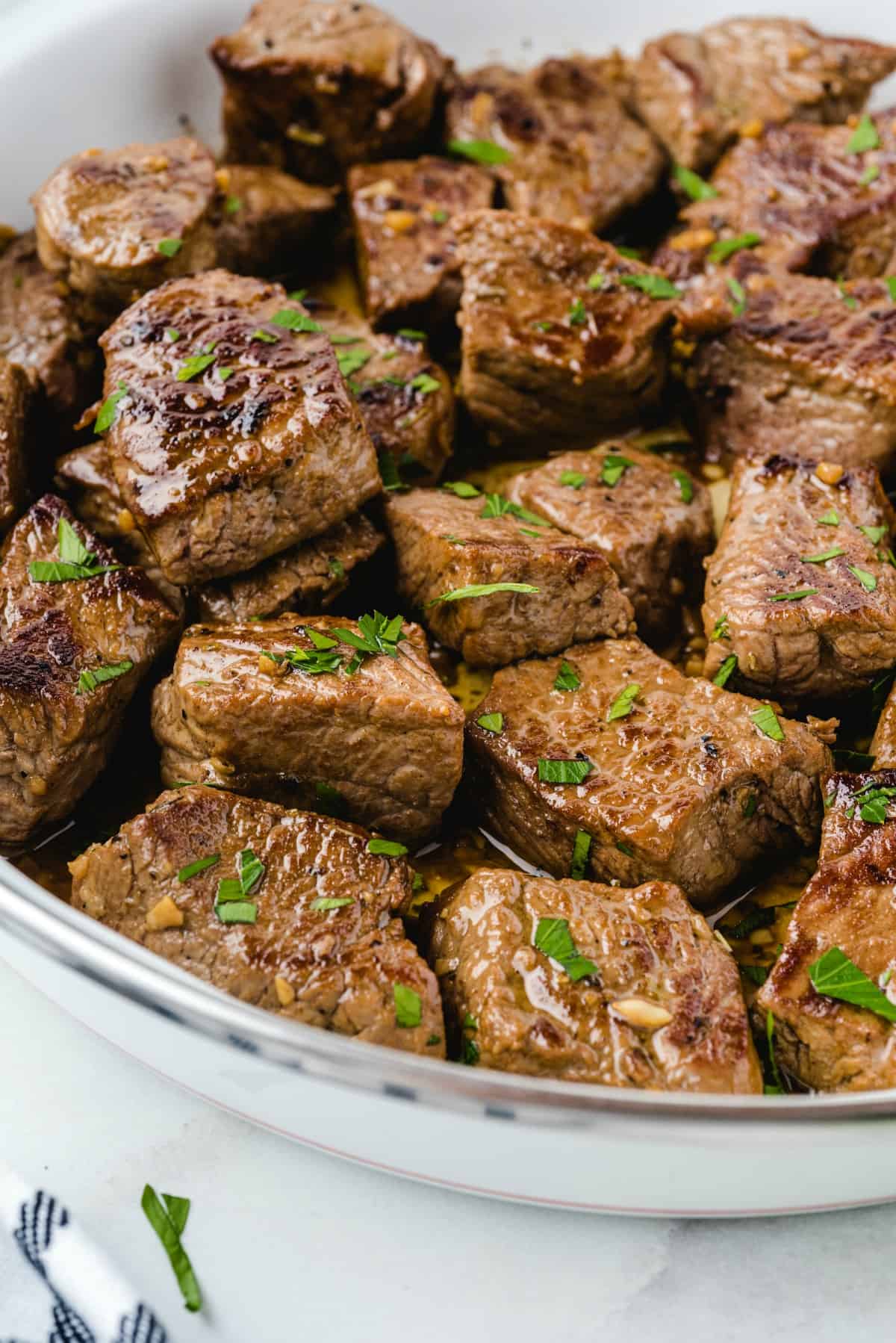 steak bites garnished with parsley. 