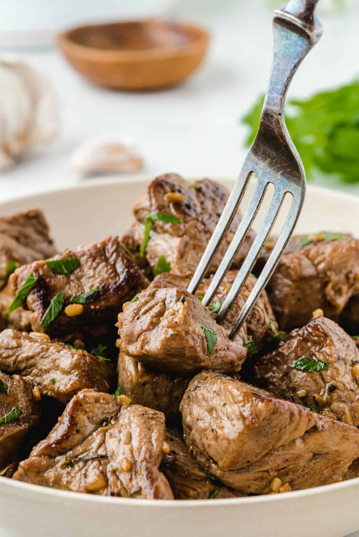 fork picking up steak bites.