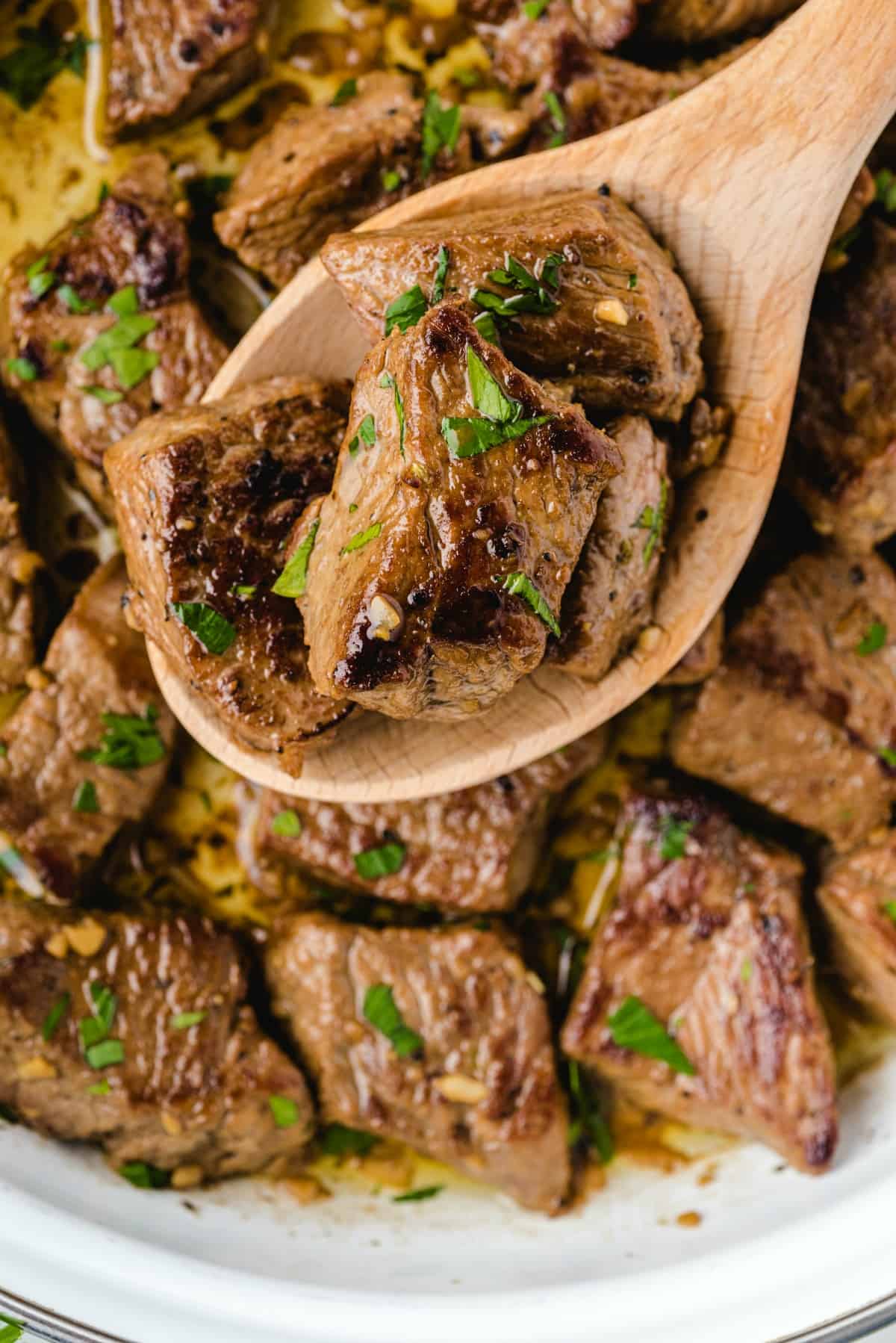 garlic butter steak bites with parsley. 