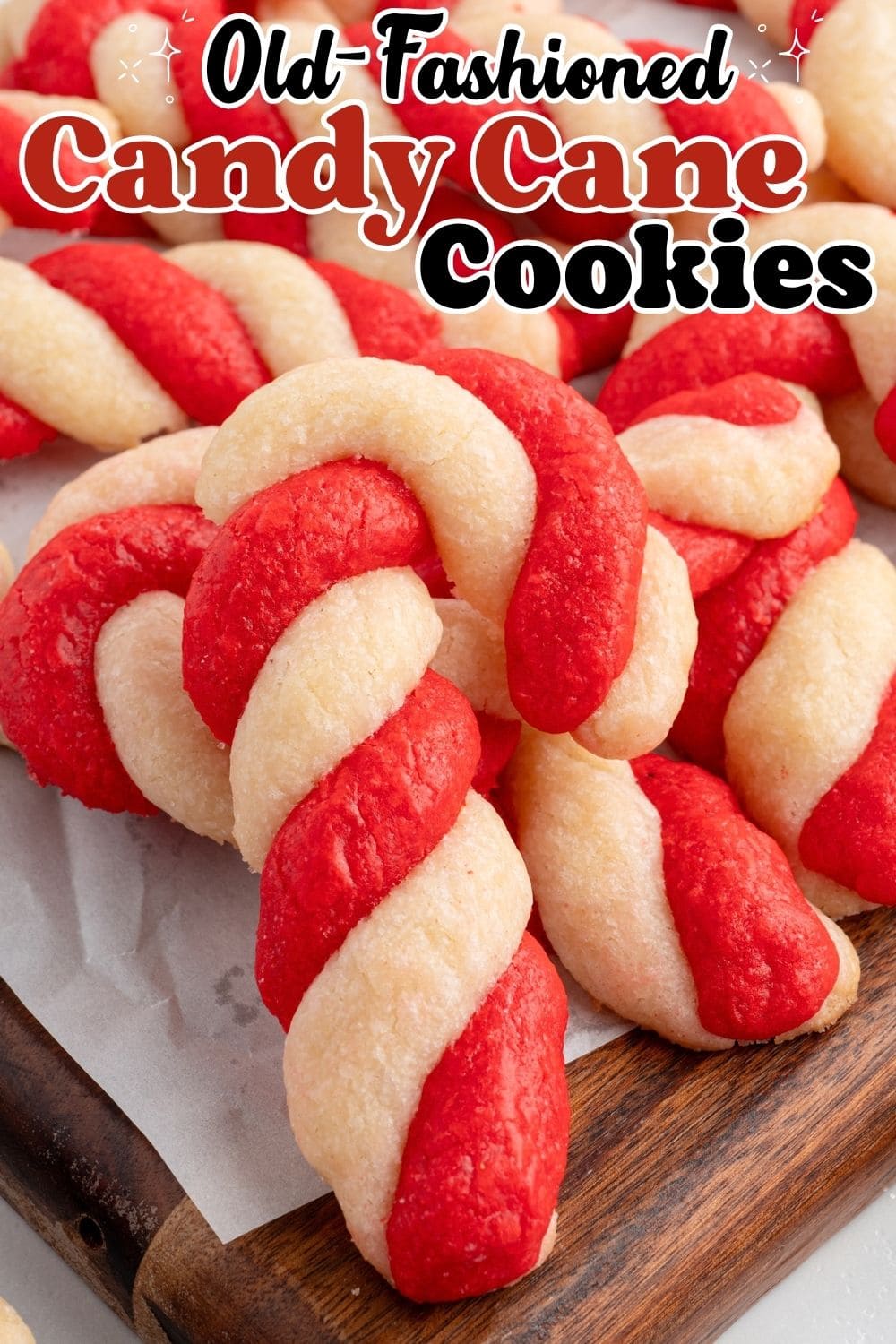 Pinterest graphic for old-fashioned candy cane cookies, showing twisted red and white cookies on a wood board.