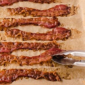 a baking sheet filled with crispy oven-baked bacon.