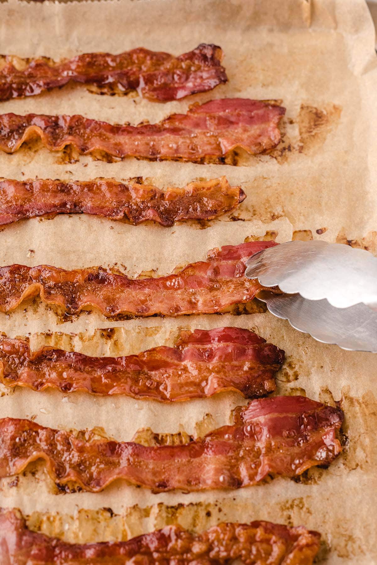 oven baked bacon on top of parchment paper. 