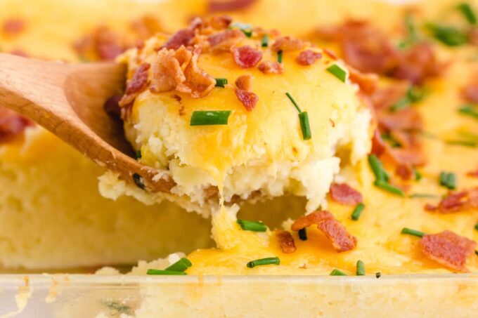 mashed potato casserole scooped out using wooden spoon