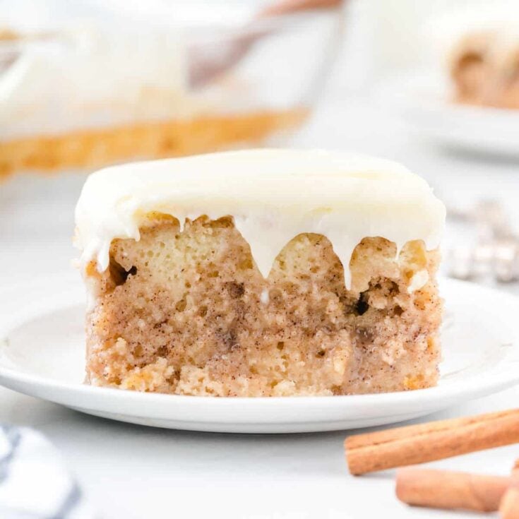 a slice of cinnamon roll poke cake.