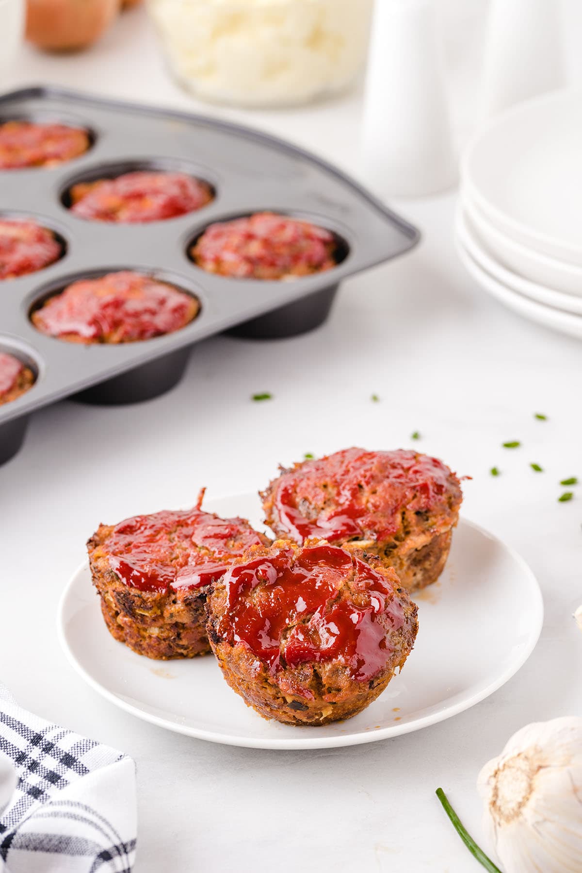 3 pieces of muffin pan meatloaf served on a white plate. 