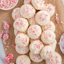 peppermint cookies piled on top of wooden board.