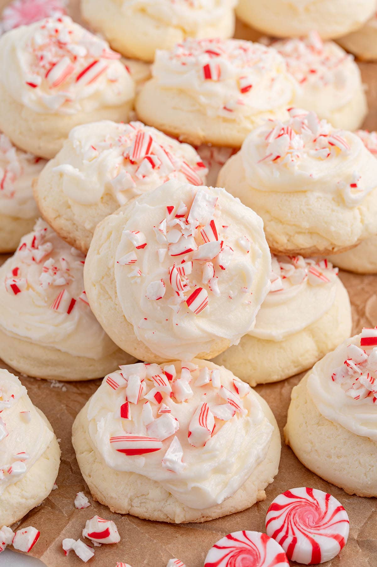 a couple of peppermint meltaways on the table topped with frosting and crushed peppermint.