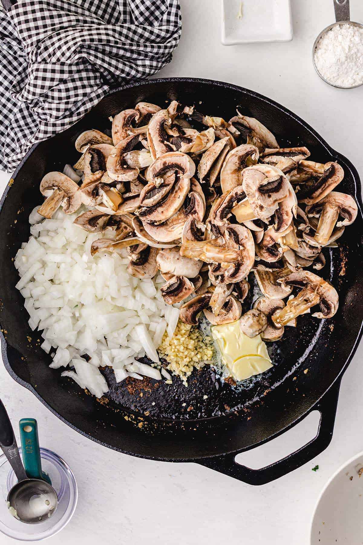 butter, minced garlic, onion, and mushrooms in a frying pan