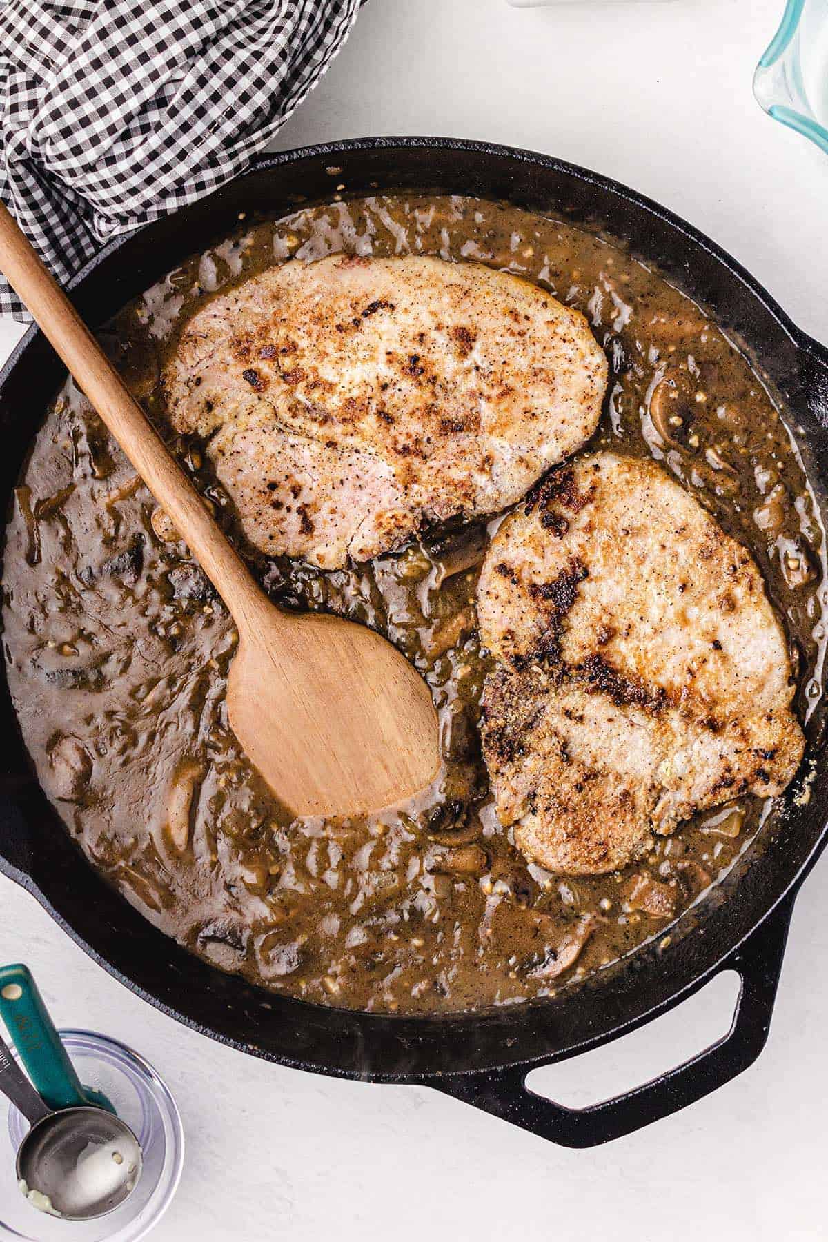 pork chops added to the mixture in a pan