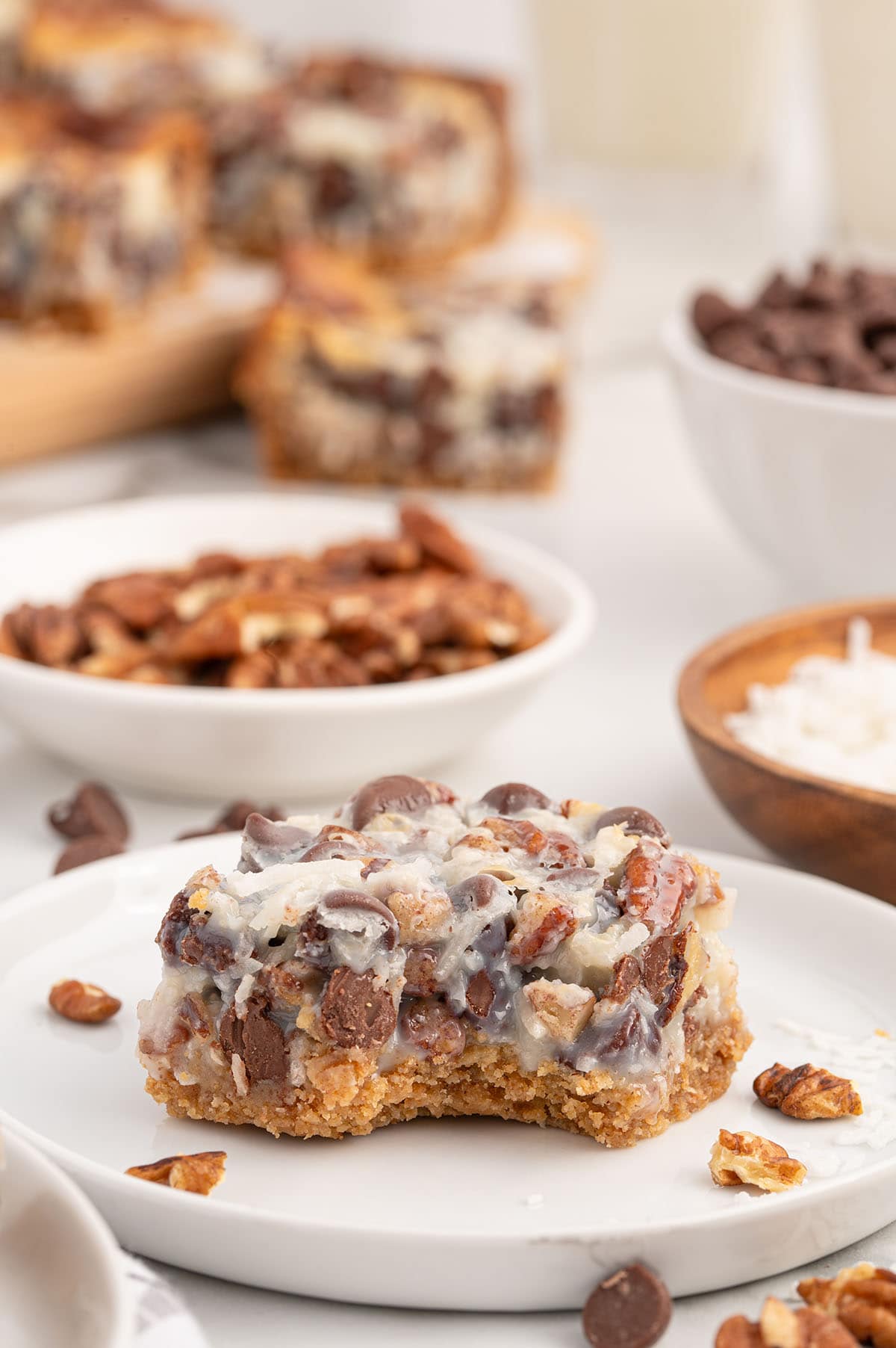 bitten magic cookie bars on top of white plate. 